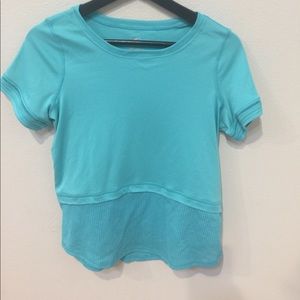 KID’S TEAL SHIRT WITH MESH AT THE BOTTOM